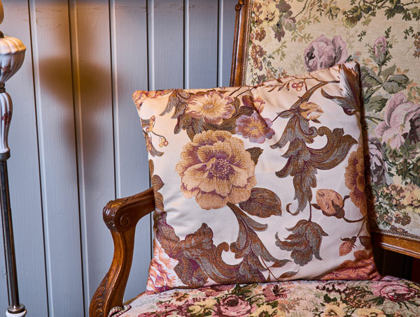 decorative pillow with floral pattern on ornate chair in vintage setting featuring 7 unique design elements